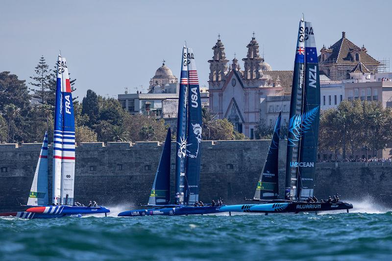 France SailGP Team helmed by Quentin Delapierre, USA SailGP Team helmed by Jimmy Spithill, and New Zealand SailGP Team helmed by Peter Burling sail past the Cadiz Cathedral on Race Day 1 of the Spain Sail Grand Prix in Cadiz, Andalusia, Spain photo copyright Felix Diemer for SailGP taken at  and featuring the F50 class