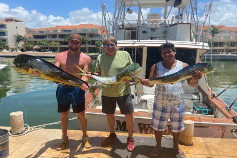 Friends enjoying a recreational fishing trip where they caught two bull and one cow dolphinfish (Atlantic mahi mahi) photo copyright Ellie Hartman taken at  and featuring the Fishing boat class