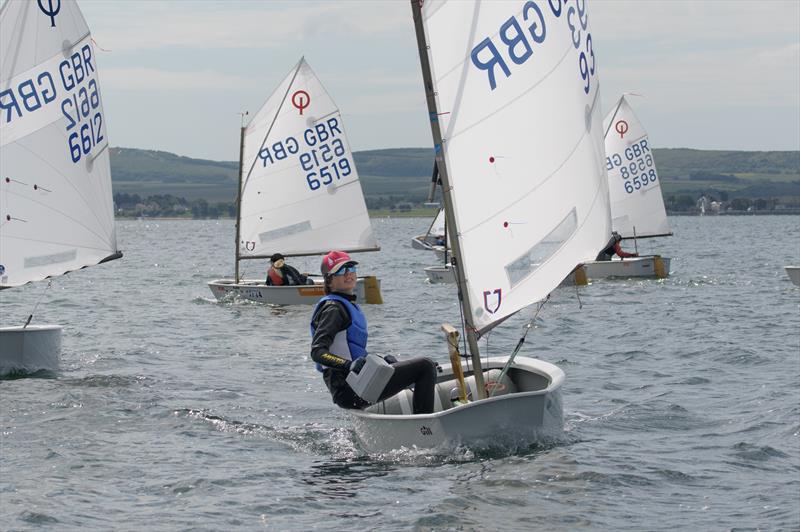 Lymington Optimist Open winner Archie sailing and bailing photo copyright Adam Gosling taken at Royal Lymington Yacht Club and featuring the Optimist class