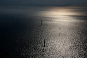Wind turbines sit in the North Sea at the London Array offshore wind farm, a partnership between Dong Energy A/S, E.ON AG and Abu Dhabi-based Masdar, in the Thames Estuary, U.K., on Tuesday, Oct. 27, 2015. The London Array, east of London, has 175 Siemens turbines and a capacity of 630MW. photo copyright Getty Images taken at  and featuring the  class