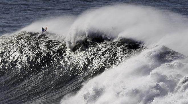 A surfer takes part in the Arnette Punta Galea Big Wave World Tour, on January 28, 2013 in the Northern Spanish Basque town of Getxo. 16 surfers took part during the five hours surf competition, riding 5 meters high waves. AFP PHOTO/ RAFA RIVAS        (Photo credit should read RAFA RIVAS/AFP/Getty Images) © Getty Images