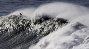 A surfer takes part in the Arnette Punta Galea Big Wave World Tour, on January 28, 2013 in the Northern Spanish Basque town of Getxo. 16 surfers took part during the five hours surf competition, riding 5 meters high waves. AFP PHOTO/ RAFA RIVAS        (Photo credit should read RAFA RIVAS/AFP/Getty Images) photo copyright Getty Images taken at  and featuring the  class