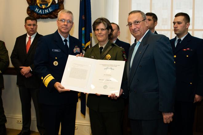 Governor Paul R. LePage and Rear Adm. Steve Poulin award Specialist Corrie Roberts the Silver Lifesaving Medal at the Maine State House in Augusta, Maine Tuesday, March 28, 2017. Roberts was recognized for her actions during a search and rescue case in October 2015 when she jumped onto a moving lobster boat to assist an unresponsive fisherman. © Petty Officer 3rd Class Andrew Barresi