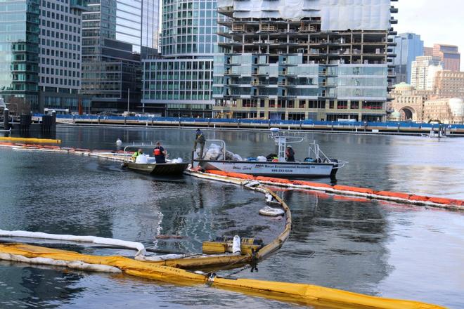 The commercial oil spill response company tends the containment boom deployed around the wreck of the ferry Peter Stuyvesant in Boston Harbor Saturday, Feb. 25, 2017. The harbor boom and sorbent work to prevent the spread of oil into Boston Harbor.  © Petty Officer 1st Class Ann Marie Borkowski