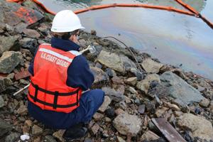Petty Officer 1st Class Ann Marie Borkowski collects a sample of the heavy fuel oil discharged into Boston Harbor during the wreck removal of the ferry Peter stuyvesant on Feb. 15, 2017. The ferry is being excavated as a part of a major redevelopment project at Pier 4. photo copyright Petty Officer 2nd Class Jonathan Clough taken at  and featuring the  class