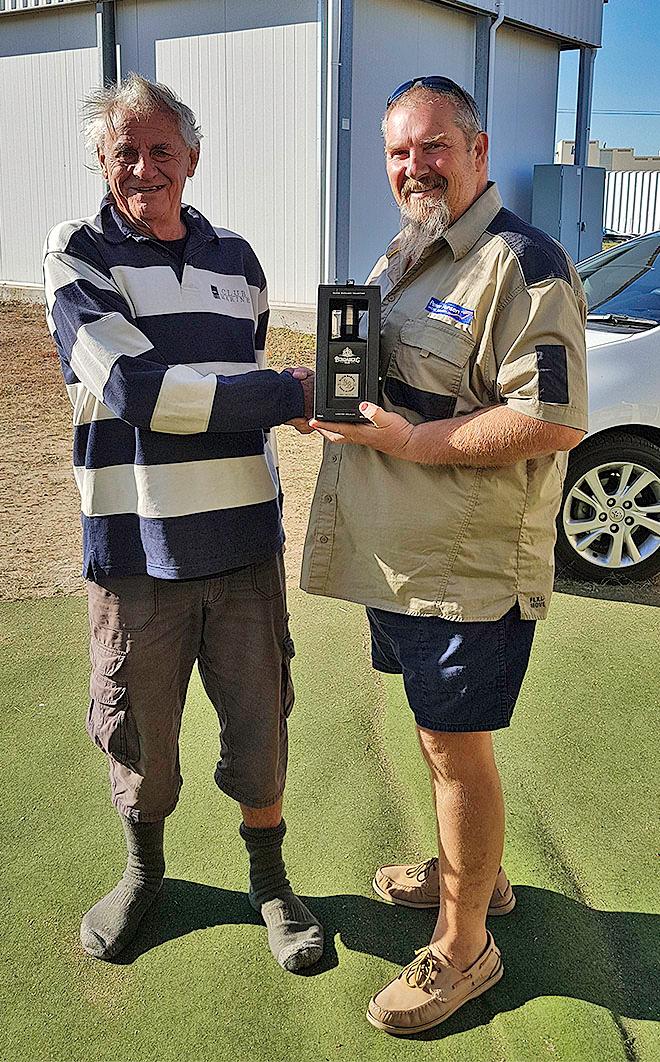 Jon receiving a bottle of 10 year old Bundaberg Rum from Michael who has followed Jon since his first circumnavigation, has read every word written by and about Jon © Maree Stainton