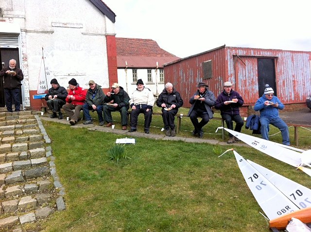 Skippers enjoying a reviving lunch of hot soup, pie & beans followed by tea or coffee, outside the clubhouse during the Paisley IOM Open photo copyright Gordon Allison taken at Paisley Model Yacht Club and featuring the One Metre class