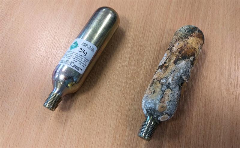 Two lifejacket cylinders; one new and one heavily corroded - photo © Mark Jardine