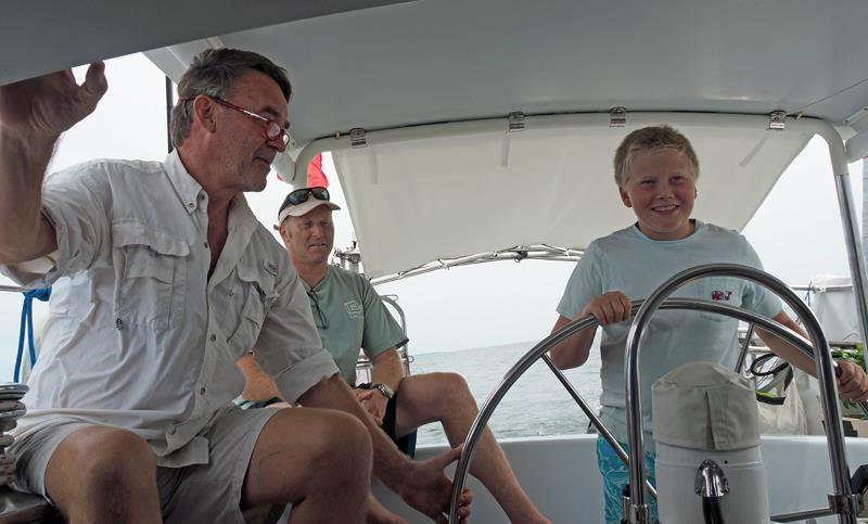 Jacob Neaderland takes the helm photo copyright SV Crystal Blues taken at  and featuring the Cruising Yacht class