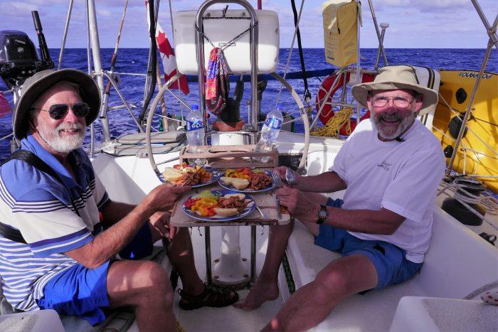 The crew feasting on the way to the Marquesas photo copyright Henk and Lisa Benckhuysen taken at  and featuring the Cruising Yacht class