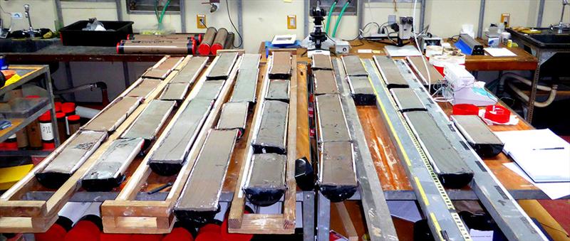 Deep-sea sediment cores shown split into halves. By analyzing the cores using high intensity X-rays, the researchers found low levels of organic carbon within the 25m yrs old sediment that were composed of a type of carbon that microbes can use for energy - photo © Kevin King