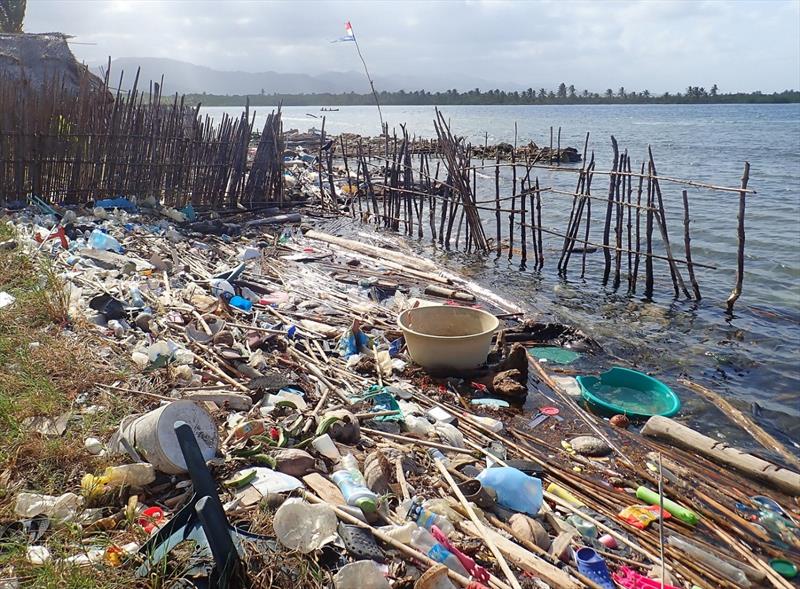 Debris lining the shores of an inhabited island photo copyright Jenevora Swann taken at  and featuring the Cruising Yacht class