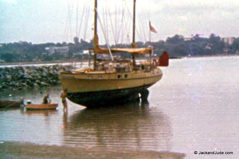 Singapore 1976 – The first time we stood Banyandah on her wide flat keel, with lines from masthead for security. Comparable to Judith's England, where huge tides leave vessels standing upright between tides - photo © Jack and Jude