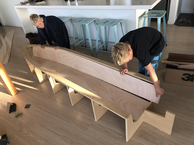 Will and Jonty Leech assembling the hull jig and see how the hull panels fit before bedtime. The project did get taken down to the workshop after this! - photo © Dan Leech