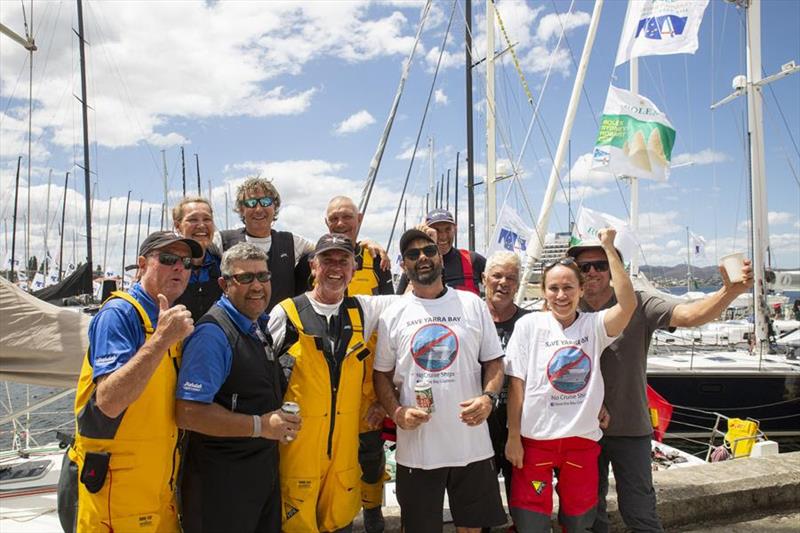 The Tribal Warrior crew, including skipper Wayne Jones (centre in black cap and yellow overalls) celebrate their successful completion of the 2019 Rolex Sydney Hobart Yacht Race photo copyright Hamish Hardy / CYCA taken at Cruising Yacht Club of Australia and featuring the IRC class