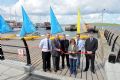 Kirsten Napier from Cunningsburgh (pictured front centre) cut a ribbon to formally open the new wooden boat deck at Lerwick Boating Club © Doug Allsop
