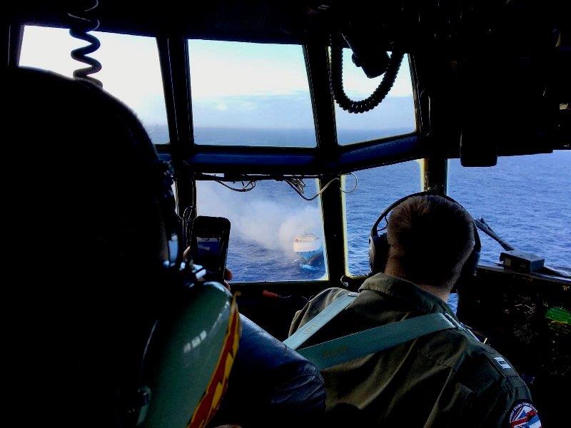 A Coast Guard HC-130 Hercules aircrew flies over the 650-foot Sincerity Ace on fire 1,800 nautical miles northwest of Oahu in the Pacific Ocean, Dec. 31, 2018. - photo © U.S. Coast Guard / HC-130 Hercules 1720