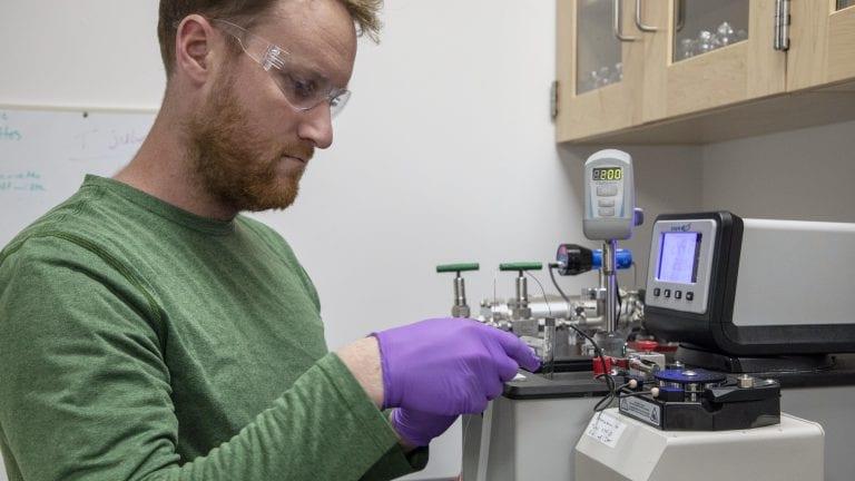 Collin Ward, a marine chemist at WHOI, works on polystyrene samples in his lab.  - photo © Jayne Doucette, Woods Hole Oceanographic Institution