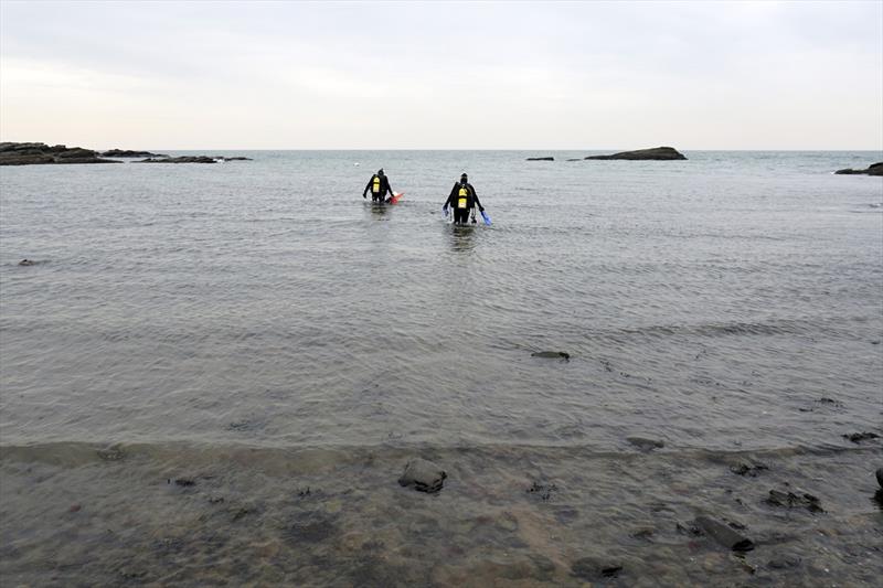 Sean Grace and Gabriella Dipreta wade into Long Island Sound to collect Astrangia corals. - photo © NOAA Fisheries