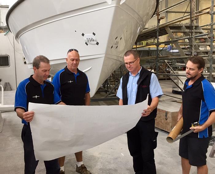 Project Manager, Colin Steber; Supply Chain Controller, Finn Stricker; Development Engineer/Research Officer, Steve Hunt and Production Controller, Mark Facer review the General Arrangement of the Steber 40 under construction at the company's Taree factor - photo © John Bulmer