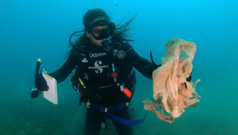 Safety diver Karina Erazo holds up a piece of plastic found in the waters surrounding Valencia, Spain, during Oceana's seafloor plastics survey in October 2020 photo copyright Oceana / Enrique Talledo taken at 